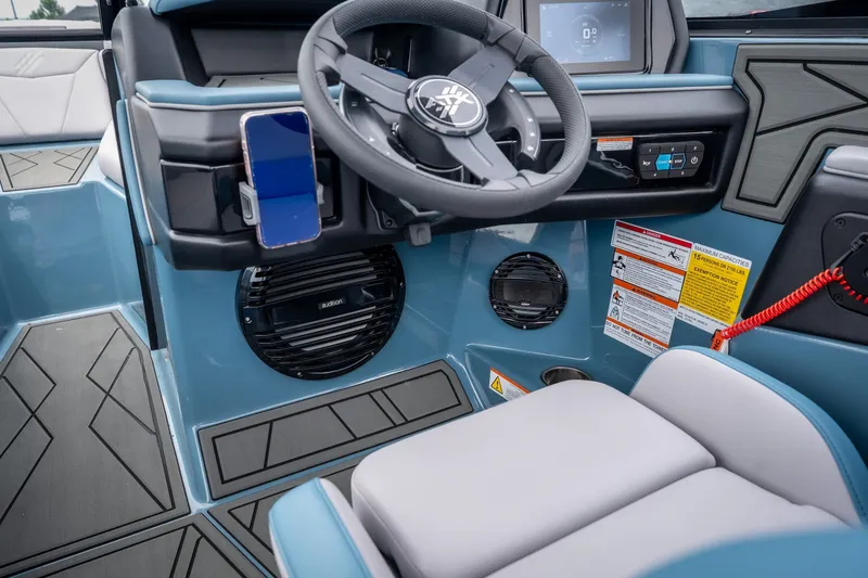 Slide: The Image of 2026 ATX Surf Boats 22 Type-S interior with steering wheel, dashboard, and phone holder. - 17