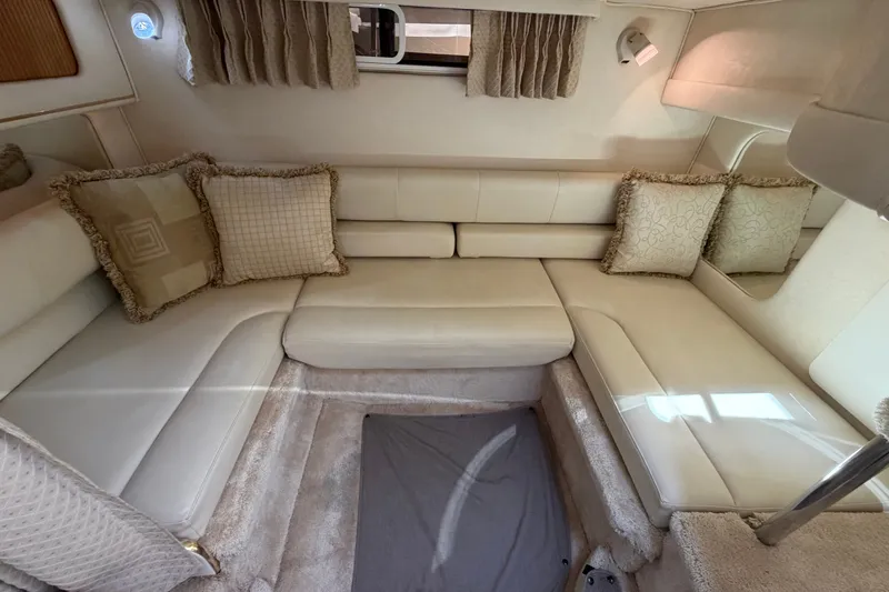 Slide: The Image of 1999 Sea Ray Sundancer 310 interior with beige seating and decorative pillows. - 33