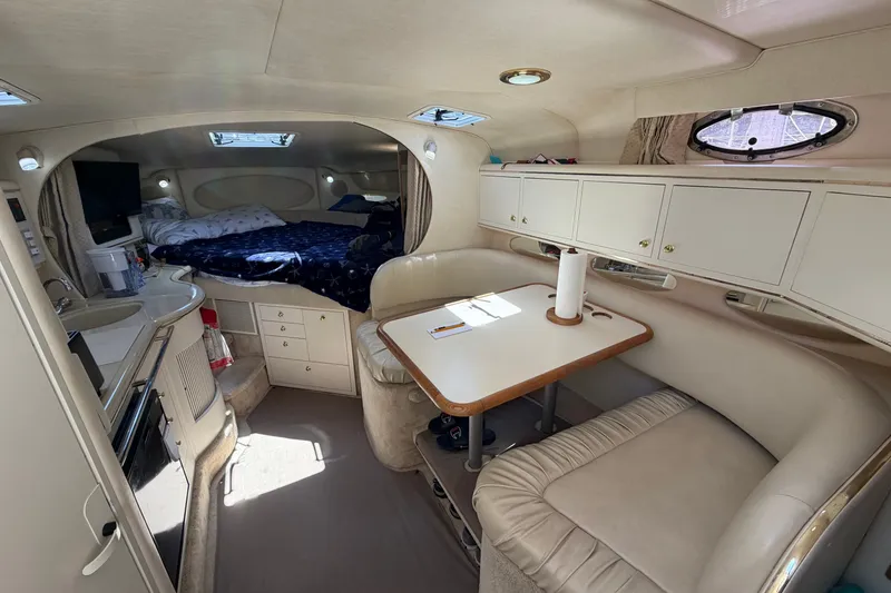 Slide: The Image of Interior of 1999 Sea Ray Sundancer 310 yacht with cozy seating and sleeping area. - 19