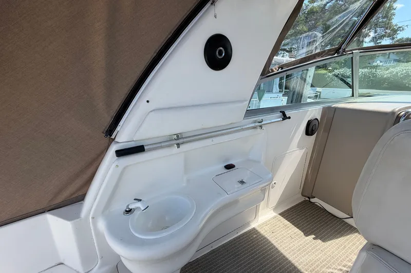 Slide: The Image of Interior of 1999 Sea Ray Sundancer 310 boat with sink and seating area. - 13