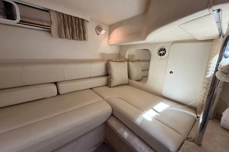 Slide: The Image of Interior of 1999 Sea Ray Sundancer 310 with beige seating and decorative pillows. - 35