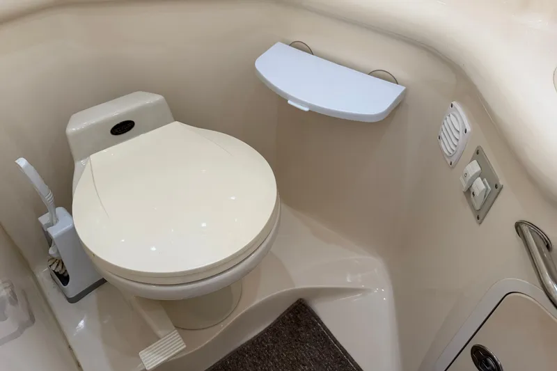 Slide: The Image of Bathroom interior of 1999 Sea Ray Sundancer 310 yacht, featuring a compact toilet. - 31