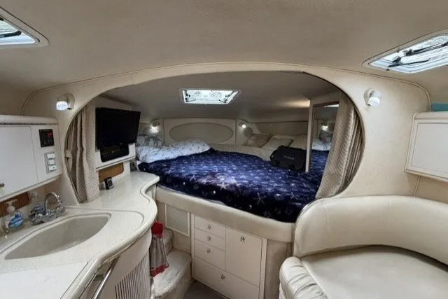Slide: The Image of Interior of a 1999 Sea Ray Sundancer 310 yacht with cozy sleeping area and kitchenette. - 20