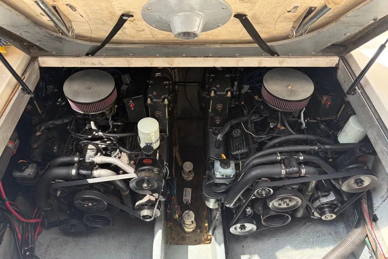 Slide: The Image of Twin engines of a 1999 Sea Ray Sundancer 310 boat, showcasing mechanical components. - 39