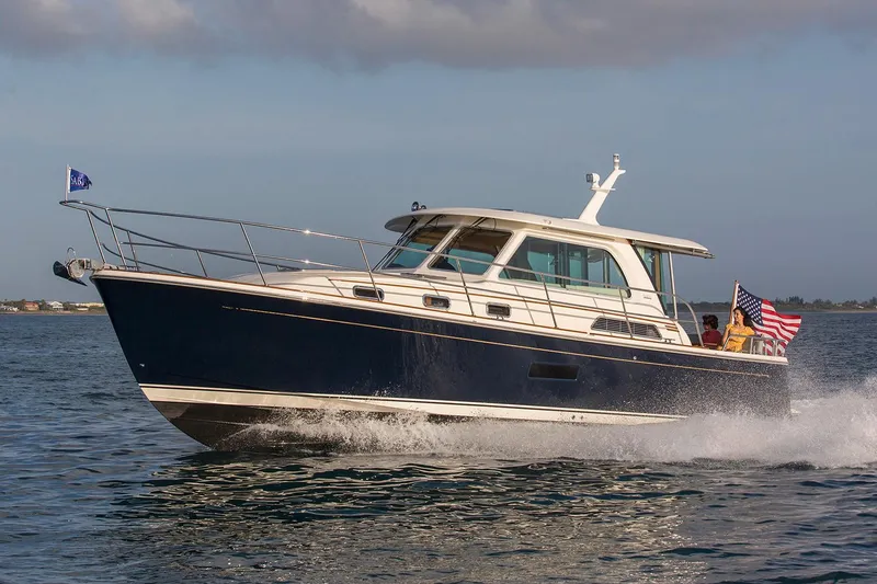 The Image of Manufacturer Provided Image: 2026 Sabre 38 Salon Express cruising on open water, displaying sleek design and American flag. - 0
