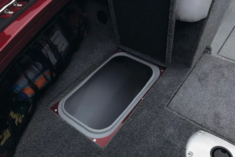Slide: The Image of A gray, rectangular storage hatch on a carpeted boat deck. - 25