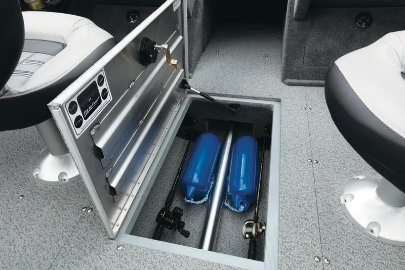Slide: The Image of An open storage compartment in a boat's floor reveals blue fenders and equipment. - 29