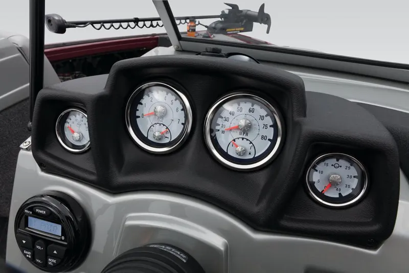 Slide: The Image of The dashboard of a 2017 Tracker Targa V-18 Combo with multiple gauges and a radio. - 38