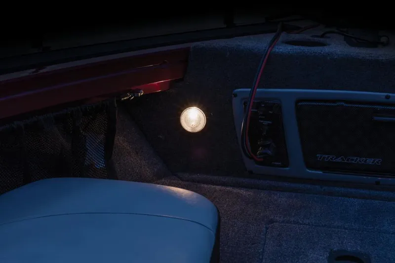 Slide: The Image of The image shows the interior of a Tracker Targa V-18 Combo boat with lighting. - 21