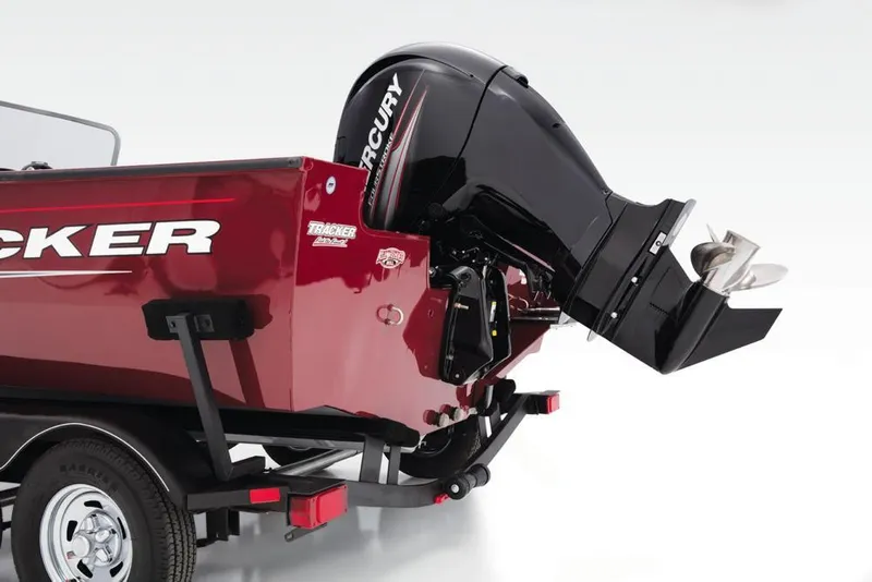 Slide: The Image of A red Tracker boat with a Mercury outboard motor on a trailer. - 48
