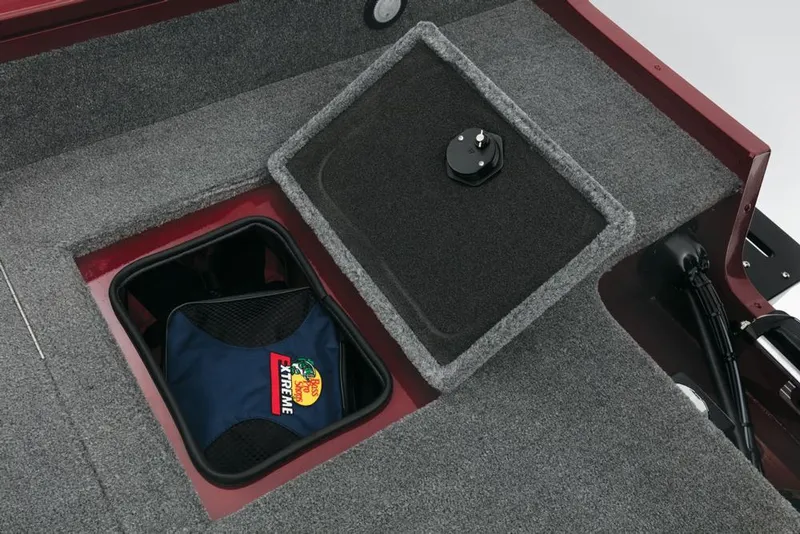 Slide: The Image of A gray carpeted storage area on a boat with an open hatch and a bag inside. - 34