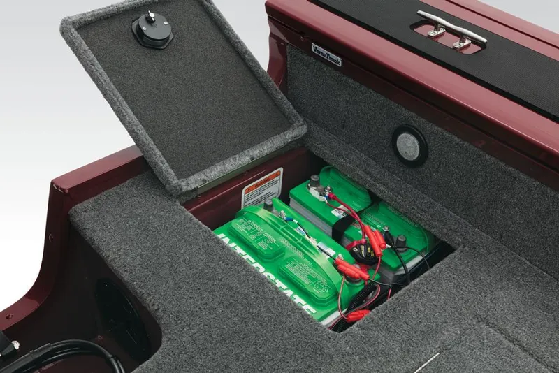 Slide: The Image of An open battery compartment with green batteries and cables in a boat. - 35
