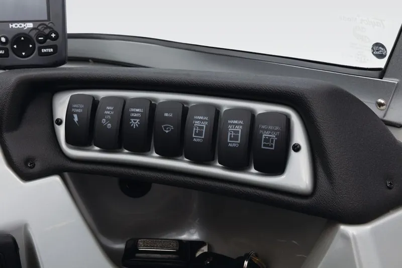 Slide: The Image of The image shows the dashboard of a Tracker Targa V-18 Combo with multiple switches. - 30