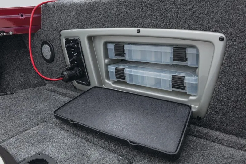 Slide: The Image of A gray storage compartment with two transparent boxes and a black lid inside a boat. - 22