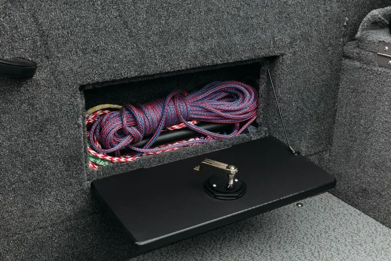 Slide: The Image of A storage compartment in the boat with a rope and a black cover. - 28