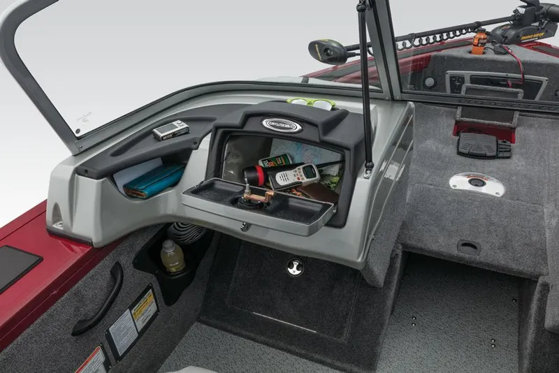 Slide: The Image of The image shows the cockpit of a 2017 Tracker Targa V-18 Combo boat with storage space. - 27