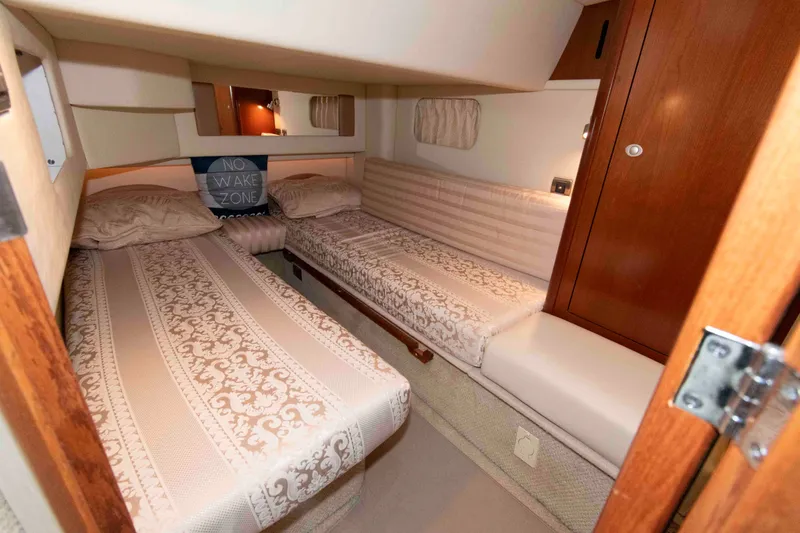 Slide: The Image of Luxurious cabin interior of 2006 Sea Ray 44 Sedan Bridge with twin beds and elegant decor. - 21