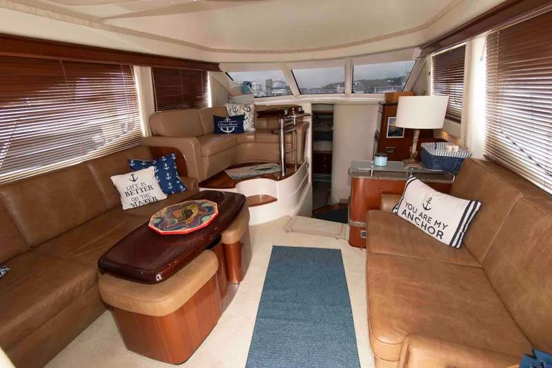 Slide: The Image of Luxurious interior of 2006 Sea Ray 44 Sedan Bridge yacht with cozy seating and nautical decor. - 13