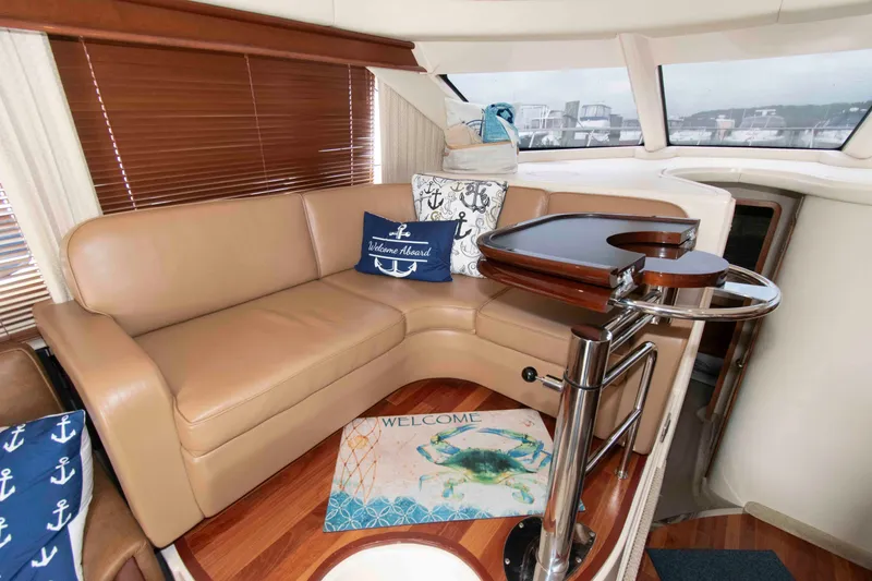 Slide: The Image of Luxurious interior of 2006 Sea Ray 44 Sedan Bridge with leather seating and nautical decor. - 16