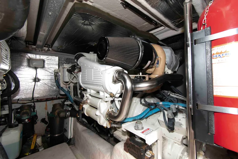 Slide: The Image of Engine room of a 2006 Sea Ray 44 Sedan Bridge yacht, featuring mechanical components. - 26
