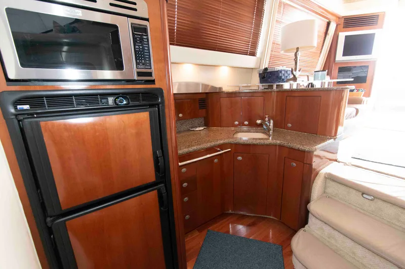 Slide: The Image of Luxurious 2006 Sea Ray 44 Sedan Bridge yacht interior with modern kitchen amenities. - 17