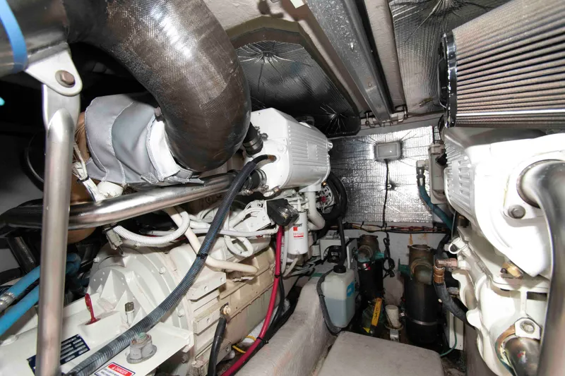 Slide: The Image of Engine room of 2006 Sea Ray 44 Sedan Bridge, showcasing mechanical components and wiring. - 27