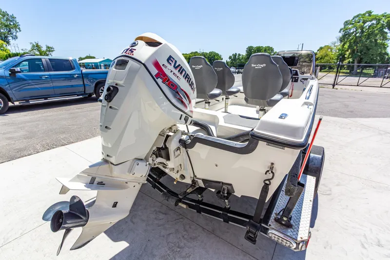 Slide: The Image of 2009 Yarcraft 1785 SC boat with Evinrude motor on trailer, parked outdoors. - 4