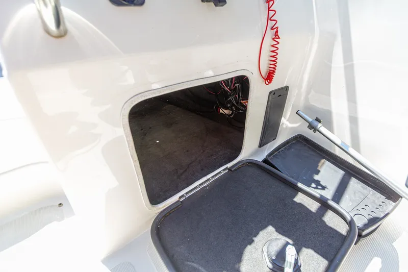 Slide: The Image of 2009 Yarcraft 1785 SC boat interior storage compartment with visible wiring. - 18