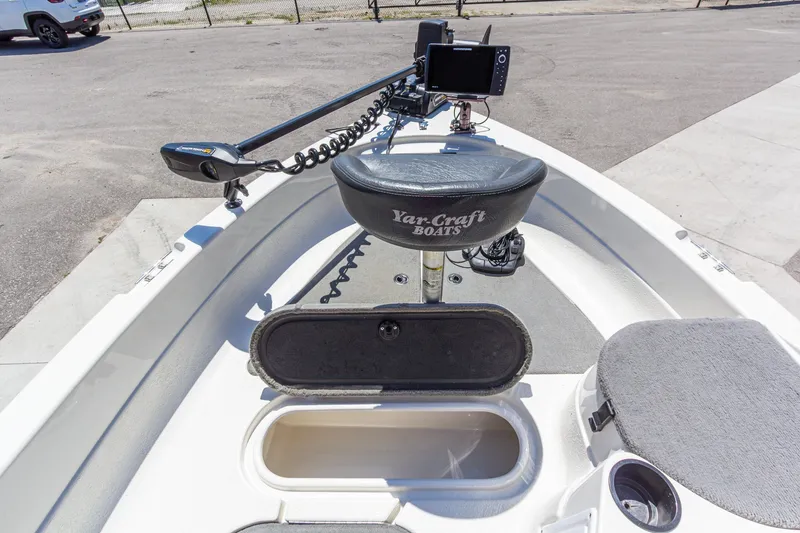 Slide: The Image of 2009 Yarcraft 1785 SC boat interior with seat, storage, and fishing equipment. - 23