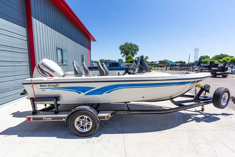 Slide: The Image of 2009 Yarcraft 1785 SC boat on trailer, parked outside a building. - 2