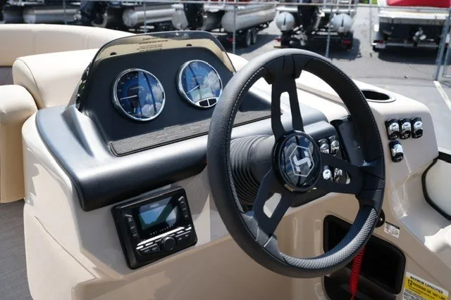 Slide: The Image of Steering console of 2027 Harris Cruiser 210 SLDH boat with gauges and controls. - 14