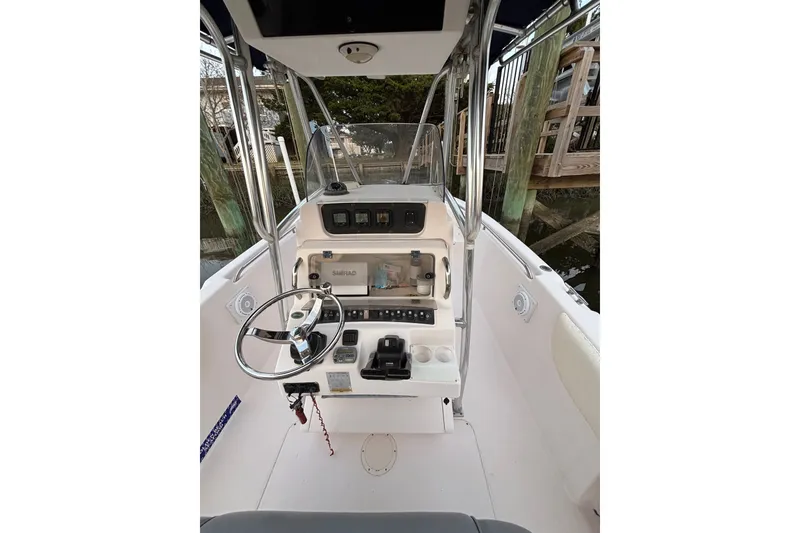 Slide: The Image of 2006 Grady-White Advance 257 boat console with steering wheel and navigation equipment. - 7