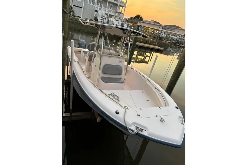 Slide: The Image of 2006 Grady-White Advance 257 boat docked at sunset, showcasing sleek design. - 4