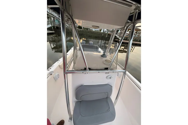 Slide: The Image of 2006 Grady-White Advance 257 boat interior with seating and console, dockside view. - 6