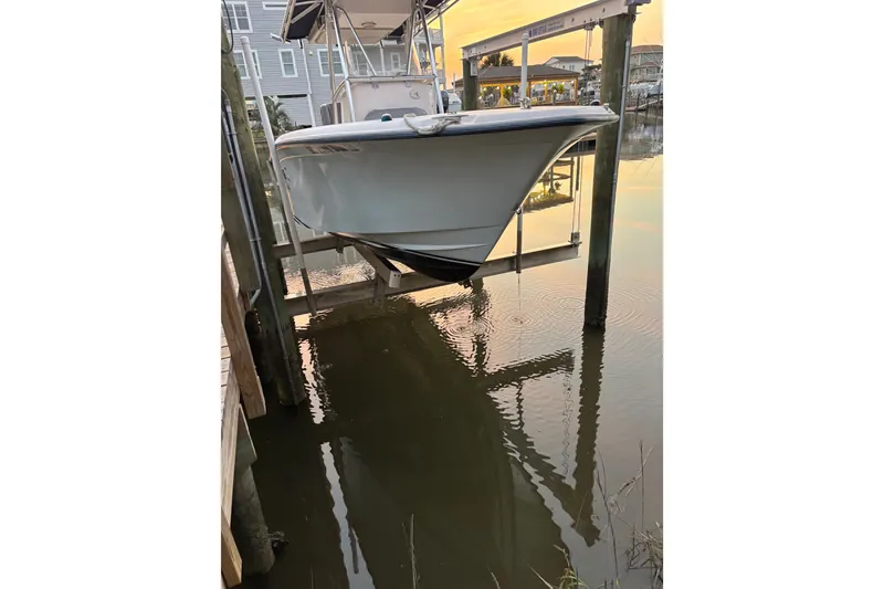 Slide: The Image of 2006 Grady-White Advance 257 boat on lift at sunset, dockside view. - 3