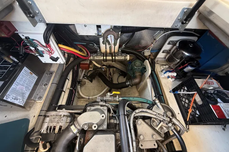 Slide: The Image of Engine compartment of a 2003 Ellis 36 Express Cruiser, showcasing mechanical components and wiring. - 47