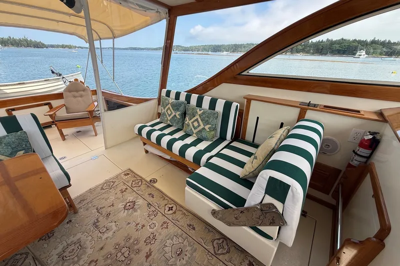 Slide: The Image of Luxurious 2003 Ellis 36 Express Cruiser interior with striped seating and scenic water view. - 38