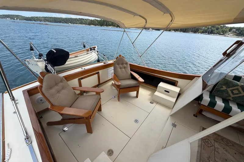 Slide: The Image of 2003 Ellis 36 Express Cruiser deck with cushioned chairs and scenic water view. - 14