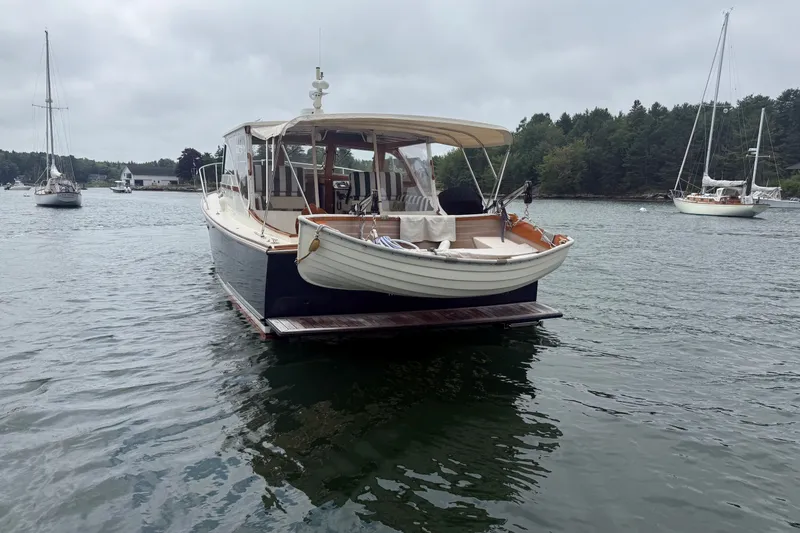 Slide: The Image of 2003 Ellis 36 Express Cruiser anchored in a serene harbor with sailboats. - 4