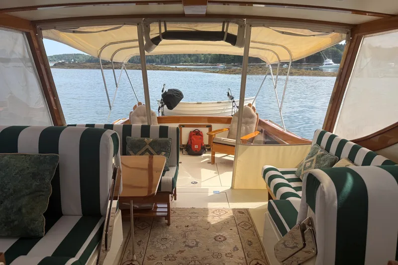 Slide: The Image of Interior of a 2003 Ellis 36 Express Cruiser with striped seating and scenic water view. - 40
