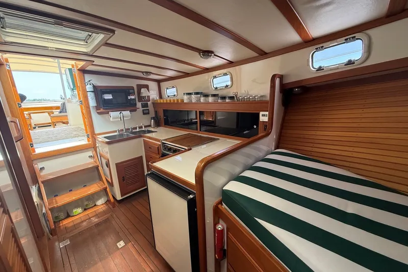 Slide: The Image of Interior of 2003 Ellis 36 Express Cruiser with kitchenette and striped seating. - 23