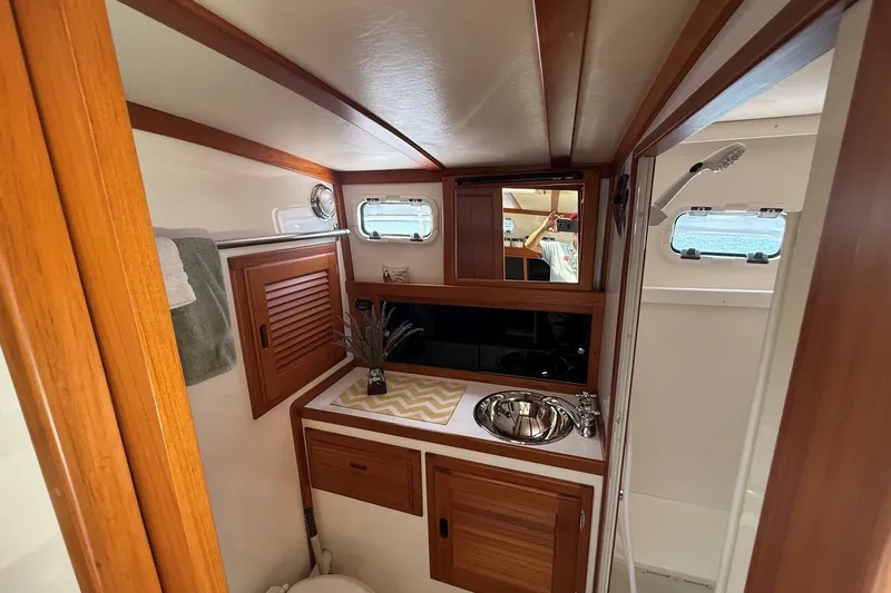 Slide: The Image of Luxurious 2003 Ellis 36 Express Cruiser bathroom with wood accents and stainless steel sink. - 30