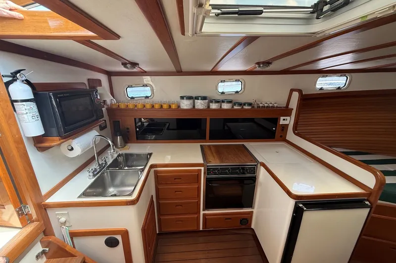 Slide: The Image of Cozy kitchen in 2003 Ellis 36 Express Cruiser with wood accents and modern appliances. - 27