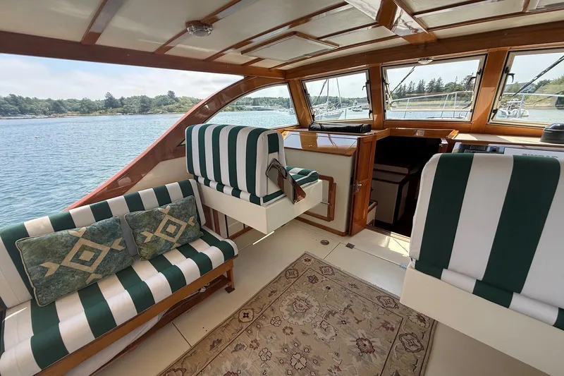 Slide: The Image of Interior of 2003 Ellis 36 Express Cruiser with striped seating and scenic water view. - 17