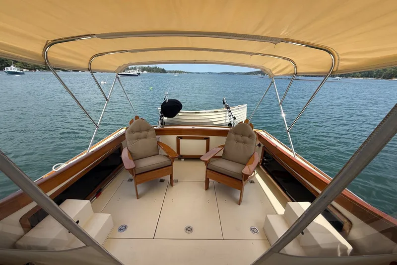Slide: The Image of 2003 Ellis 36 Express Cruiser with canopy, featuring two cushioned chairs on deck. - 13