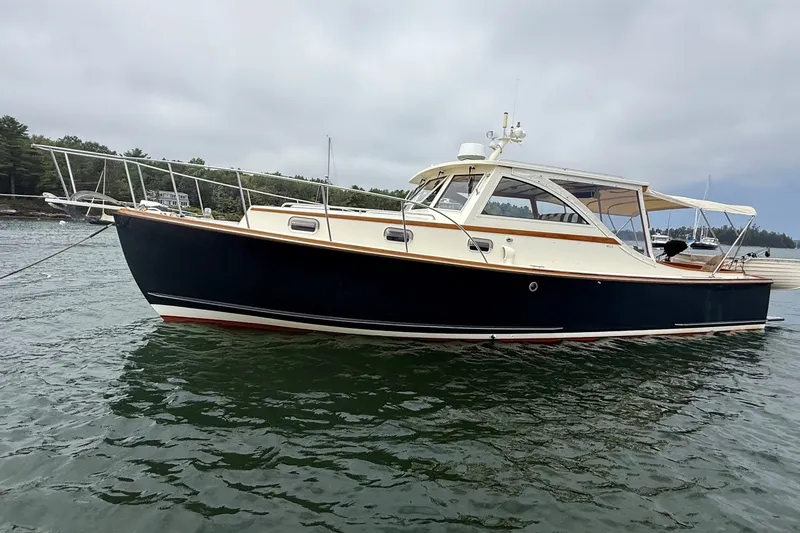The Image of 2003 Ellis 36 Express Cruiser on calm water, showcasing sleek design and classic elegance. - 0