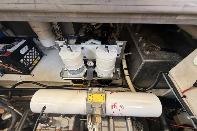 Slide: The Image of Engine compartment of a 2003 Ellis 36 Express Cruiser, showcasing filters and mechanical components. - 49