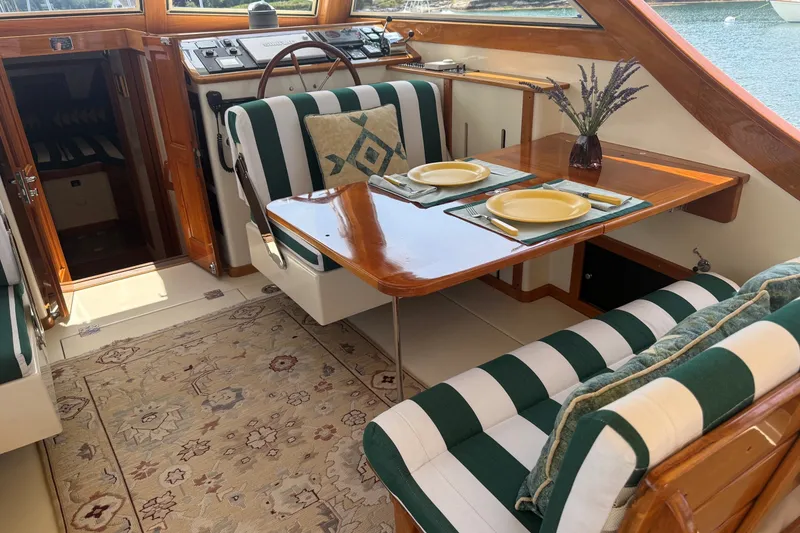 Slide: The Image of Elegant interior of 2003 Ellis 36 Express Cruiser with striped seating and dining setup. - 33