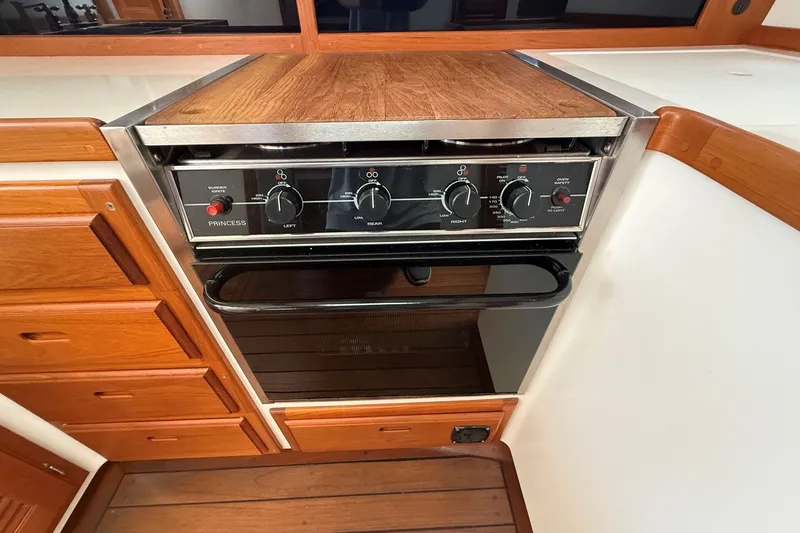 Slide: The Image of 2003 Ellis 36 Express Cruiser kitchen with Princess stove and wooden cabinetry. - 29