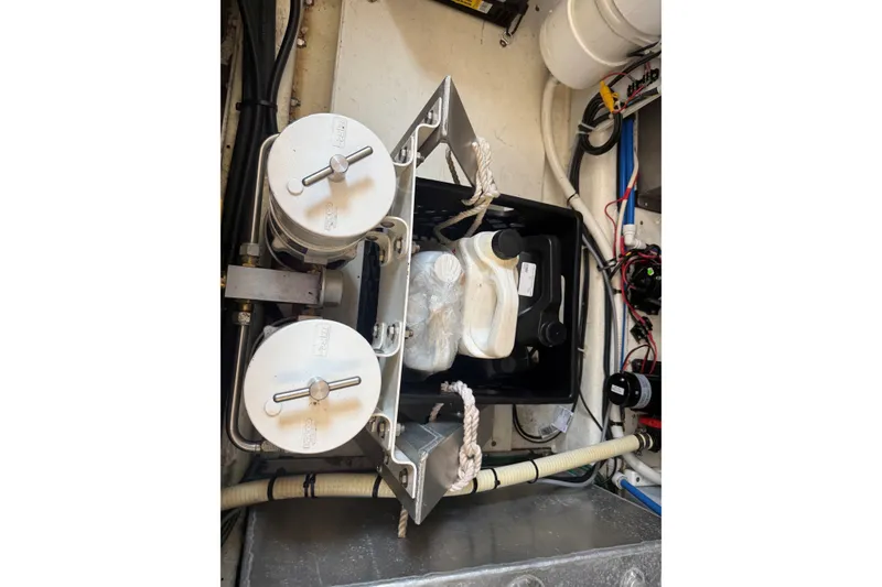 Slide: The Image of Engine room of 2003 Ellis 36 Express Cruiser with filters and storage containers. - 48